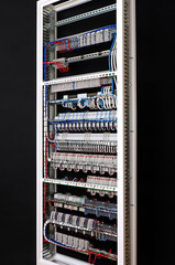 The reverse side of the electrical switchboard. The connected wires are tied with plastic ties.