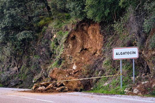 Aerial view of a landslide blocking the road, a stark contrast between the dark asphalt and the light brown earth, Algatocin, Andalusia, Spain.