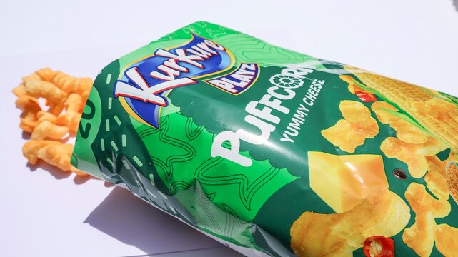 Kurkure Puffcorn yummy cheese flavour ready to eat food item in green packaging on white background bought on 8, june, 2025 in India