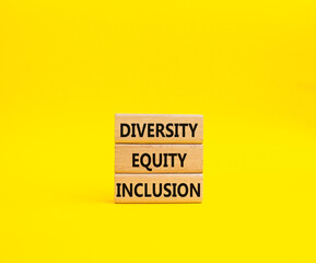 Diversity Equity Inclusion symbol. Concept words Diversity Equity Inclusion on wooden blocks. Beautiful yellow background. Business and Diversity Equity Inclusion concept. Copy space