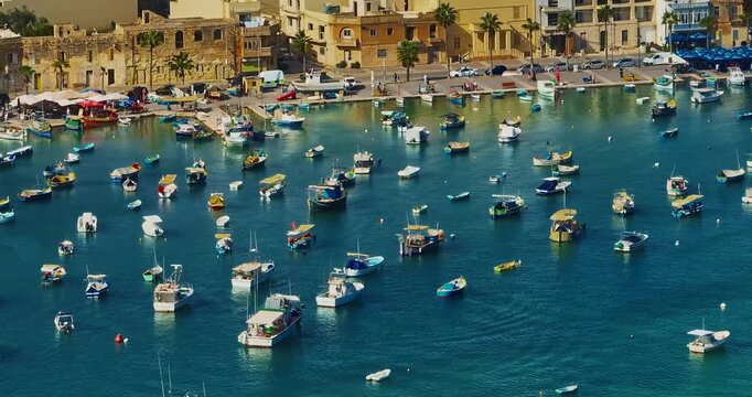 Aerial view of the Port of Marsaxlokk In Malta. A small fishing village with traditional colorful boats