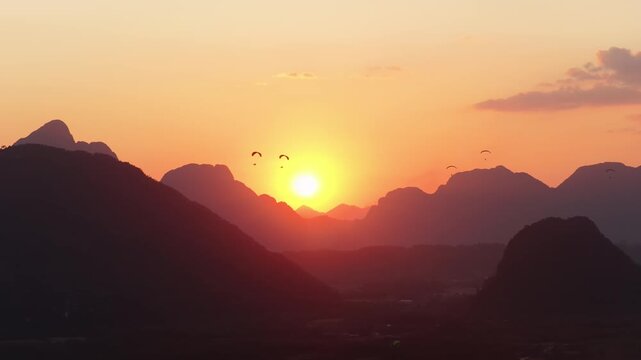 Sunset Over Mountains in Vang Vieng with Paragliders