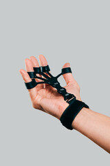 a man training grip with a finger strengthener