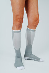 the lower legs of a man wearing compression socks