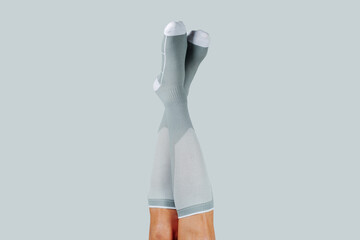 a man upside down wearing compression socks