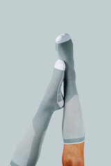 upside down man wearing gray compression socks