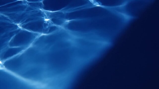 Ripples on the surface of a serene body of water captured from above in a close-up view