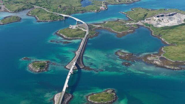 forward drone flight, top down view, Fredvang bridges, some cars on the brigde or road. Beautiful landscape seen from above, small islands, fjord, ocean. Travel theme, Beautiful Norway. Travel destina