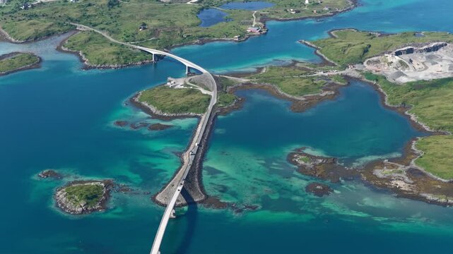 forward drone flight, top down view, Fredvang bridges, some cars on the brigde or road. Beautiful landscape seen from above, small islands, fjord, ocean. Travel theme, Beautiful Norway. Travel destina