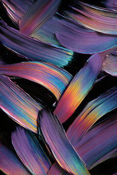 Iridescent holographic airbrush strokes on black background with luminous flowing color shifts