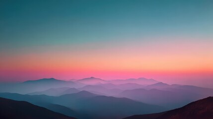 Fototapeta premium Stunning mountain range silhouette at sunset with vibrant pink and teal sky and morning mist