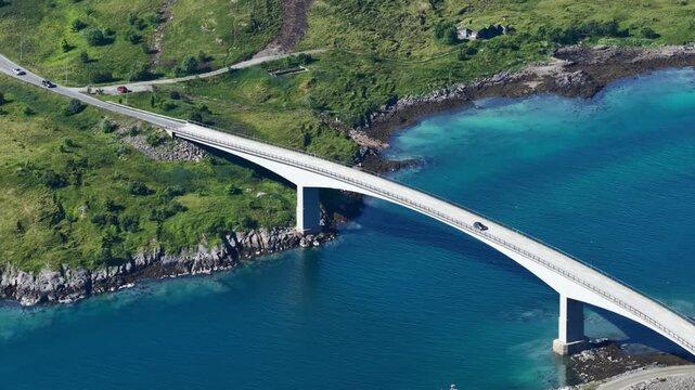 forward drone flight, high angle view, Fredvang bridges, some cars on the brigde or road. Beautiful landscape seen from above, small islands, fjord, ocean. Travel theme, Beautiful Norway. Travel desti