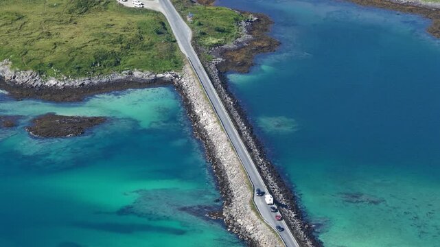 forward drone flight, high angle view, Fredvang bridges, some cars on the brigde or road. Beautiful landscape seen from above, small islands, fjord, ocean. Travel theme, Beautiful Norway. Travel desti