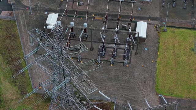 Aerial view of Enderby Substation National Grid, a network of metal structures and grey gravel contrasting with green grass, Enderby, Enderby, United Kingdom.
