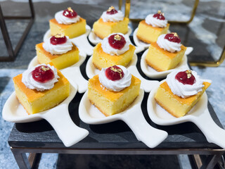 Bite size cheesecake pieces carefully sliced for catering, buffet, and event dessert presentation, ideal for parties, celebrations, hospitality service, and commercial food use.