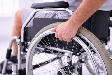 Obraz premium Physical therapy rehabilitation recuperatio progress wheelchair wheel hand male patient support clinic indoor recovery focused movement strength