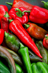 Close-up of fresh ripe colorful red and green bell peppers, top view