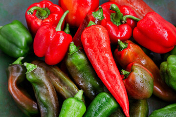 Close-up of fresh ripe colorful red and green bell peppers, top view