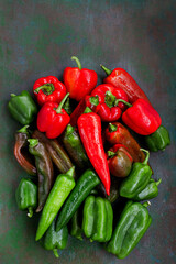 Close-up of fresh ripe colorful red and green bell peppers, top view