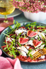 Delicious fresh fig carpaccio with burrata or stracciatella or mozzarella cheese and arugula salad