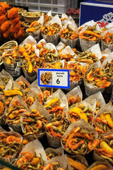 Variety of cornets with delicious seafood snacks at a street market in Barcelona, ​​Spain