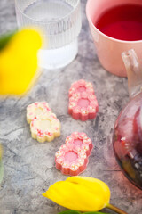 Close-up of beautifully decorated sweets in shape of number eight and spring flowers, cup of tea, Women&rsquo;s Day  spring holiday concept