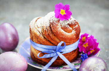 Sweet Easter bread, panettone or cruffin and colorful painted eggs, Holiday spring concept