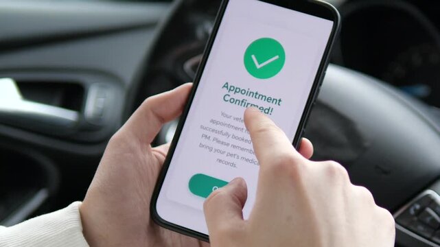 a user confirming a vet appointment on their phone while sitting in a vehicle. The screen reminds the user to bring pet medical records. This clip illustrates rthe integration of veterinary services