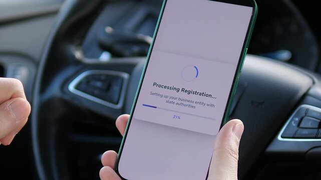 Close-up of entrepreneur confirming online company registration on smartphone in car. Tapping register button, processing screen and successful completion message. Seamless digital incorporation and