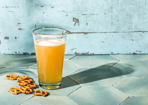 Light beer in glass on aqua tiles