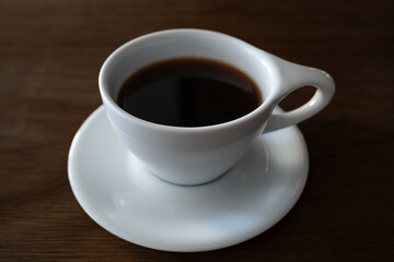 Simple coffee cup filled with coffee.