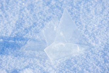 Top view of sharp ice fragments rising from powdery snow