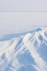 A vast snow covered frozen sea stretches to the horizon