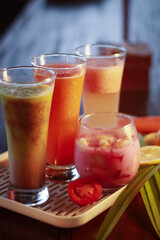 A refreshing array of colorful fruit juices and "Es Buah" served on a tray, making it the perfect choice for breaking the fast (Iftar)