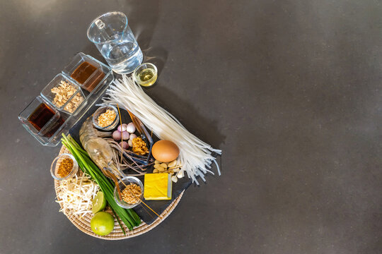 Flatlay Top Table of Pad Thai has a main ingredient such as noodle, shrimp, garlic chives, yellow tofu, chilli powder, shallot, fish sauce, palm sugar,and much more.