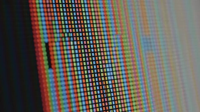 Extreme closeup of computer monitor pixels revealing red green and blue