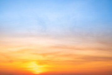 Sunset or sunrise sky with a vibrant gradient of orange, gold, and soft blue. Clear atmosphere with wispy clouds. Peaceful, natural light background. hope, freedom, new day and inspirational Concepts