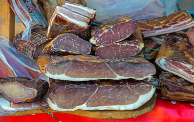 Organic cured dry homemade meat sold outside on a market stall