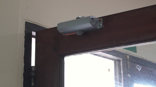 Automatic Door Closer on Wooden Door.