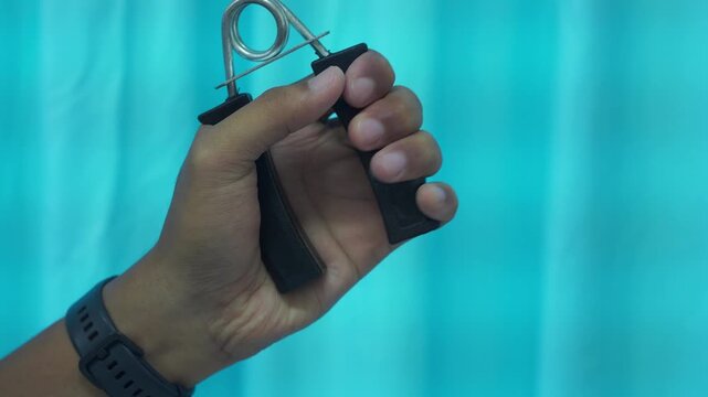 hand doing exercises with hand grip