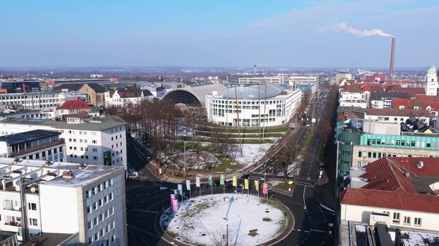 Static aerial survey of Bielefeld showcasing city hall, cityscape, and traffic circle in Willy Brandt Platz on a sunny winter day