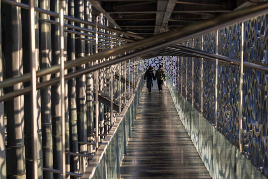 couple walk through the long walkway in france, marsellie