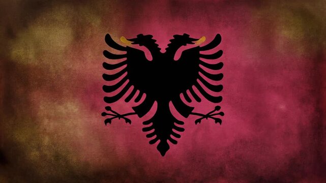 Vintage grunge style Albanian flag featuring the black double headed eagle emblem on a distressed red maroon background symbolizing Balkan nationalism and history