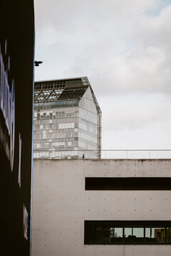Minimal concrete building facade with clean windows and simple structure beneath soft sky creating calm modern abstract background with space