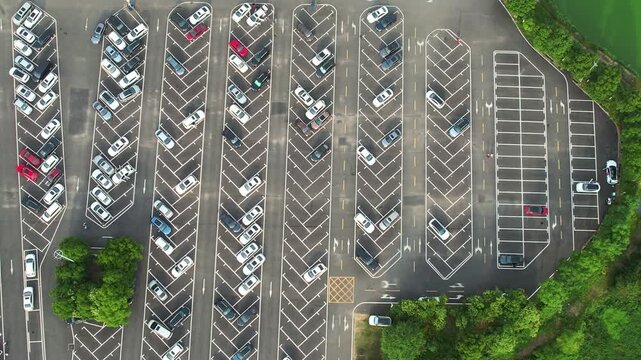 Aerial Parking Lot with Densely Packed Cars and Green Trees