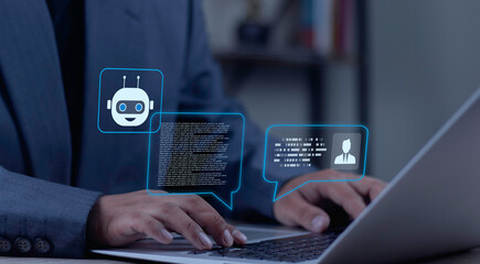 Businessman typing on laptop with AI chatbot hologram displaying robot and human user speech bubbles. Concept of online customer service, virtual assistant, and digital conversation.
