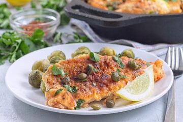 Delicious pan seared fish with capers, brussels sprouts, and lemon, horizontal