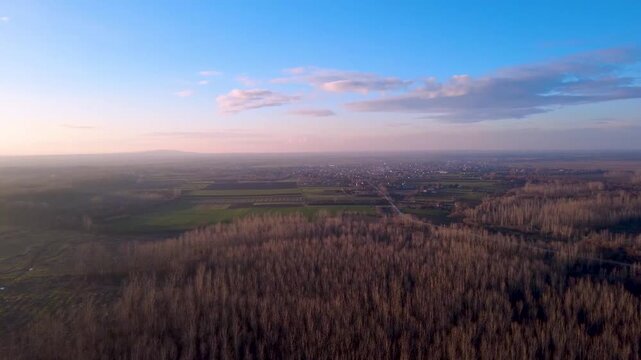 Cinematic Drone Flyover of Rural Farmland and Village at Golden Hour