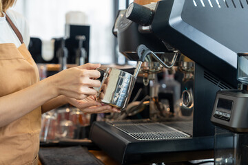 Fototapeta premium Happy barista in apron proudly welcomes customers with passion for brewing coffee at a new cafe and small business coffee shop in the morning. Owner new business sme.