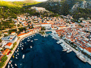 Fototapeta premium Aerial view of the historic Hvar town and the Spanish Fortress (Fortica) overlooking the harbor and Adriatic sea, Hvar island, Dalmatia, Croatia.